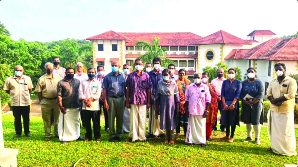 Some India Bible College and Seminary staff (on the left) with part of the COVID medical staff.  Main classroom and administration building in the background.