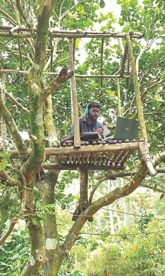 Syam Pradeep in the tree house he built to catch signals for online classes at IBC.