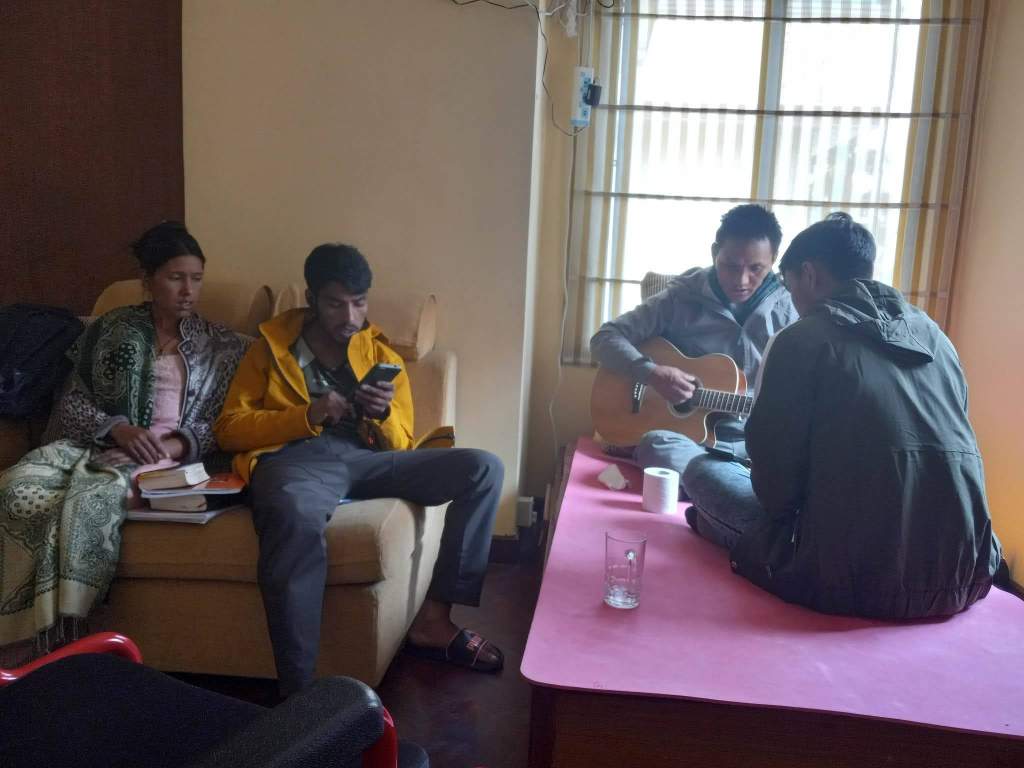 Phendey (with guitar) disciples new believers he met while in the hospital. Rodha mentors the women.
