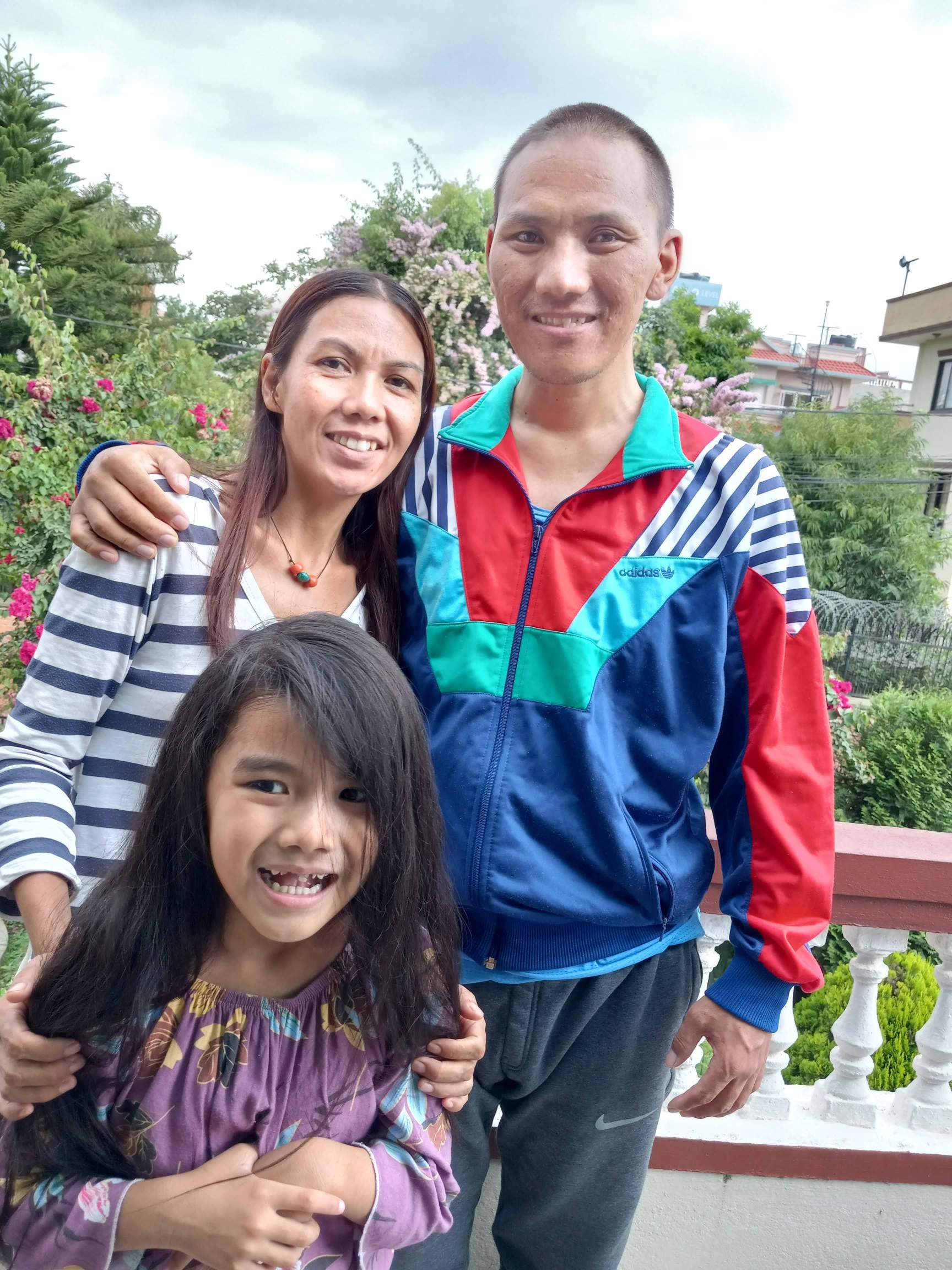 Evangelists Rodha and Phendey, with daughter Yeshe, after Phendey gained enough strength and mobility to stand on his own.