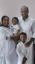 Evangelist Praisy George with her husband, Pastor Rathish, and their two young children.