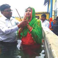The baptism of Ashok Kumar’s wife, Suman.
