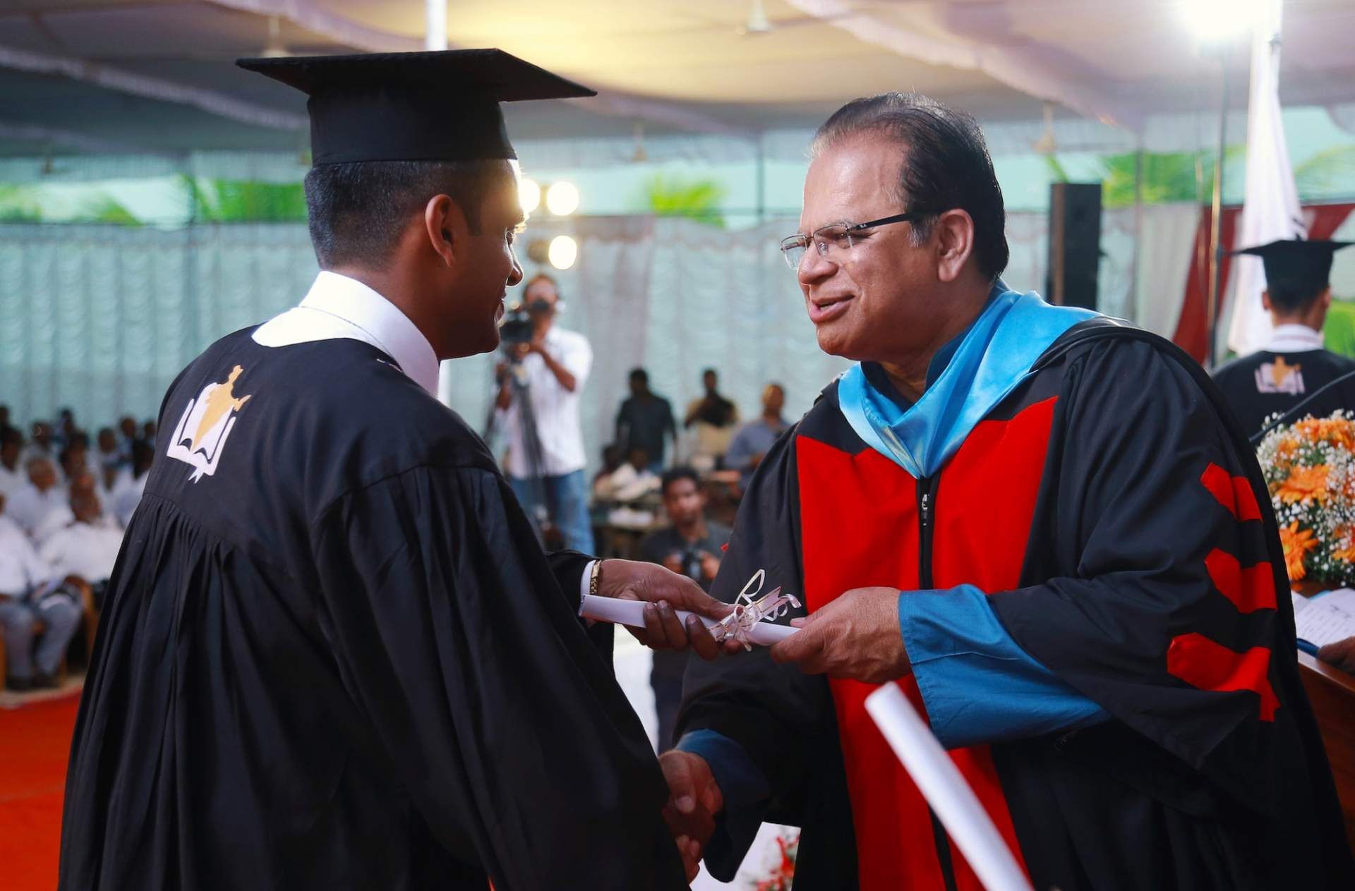 IGO President Valson Abraham presents a diploma to an IBC 2017 graduate.